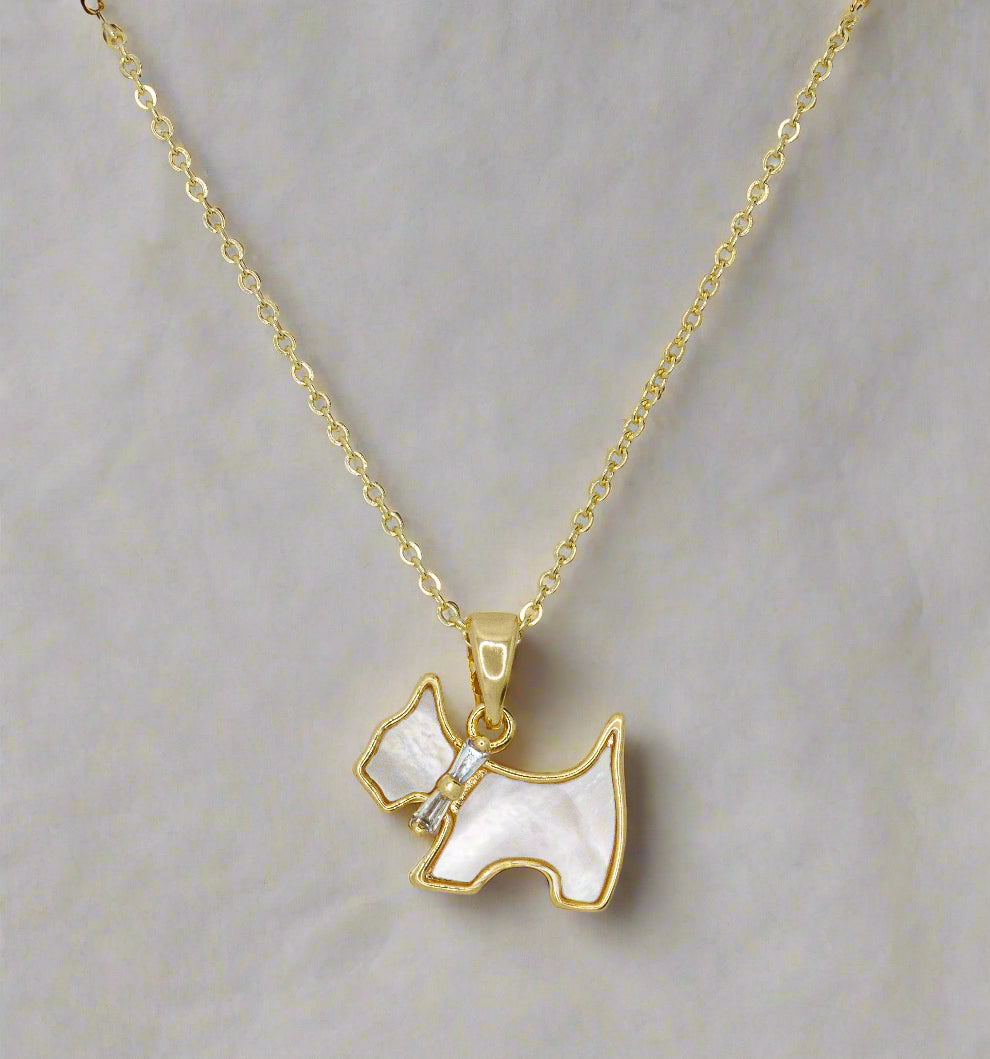 Gold necklace with a dog-shaped pendant on a light gray background
